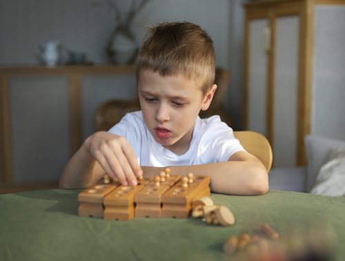 young-autistic-boy-playing-with-toys-home